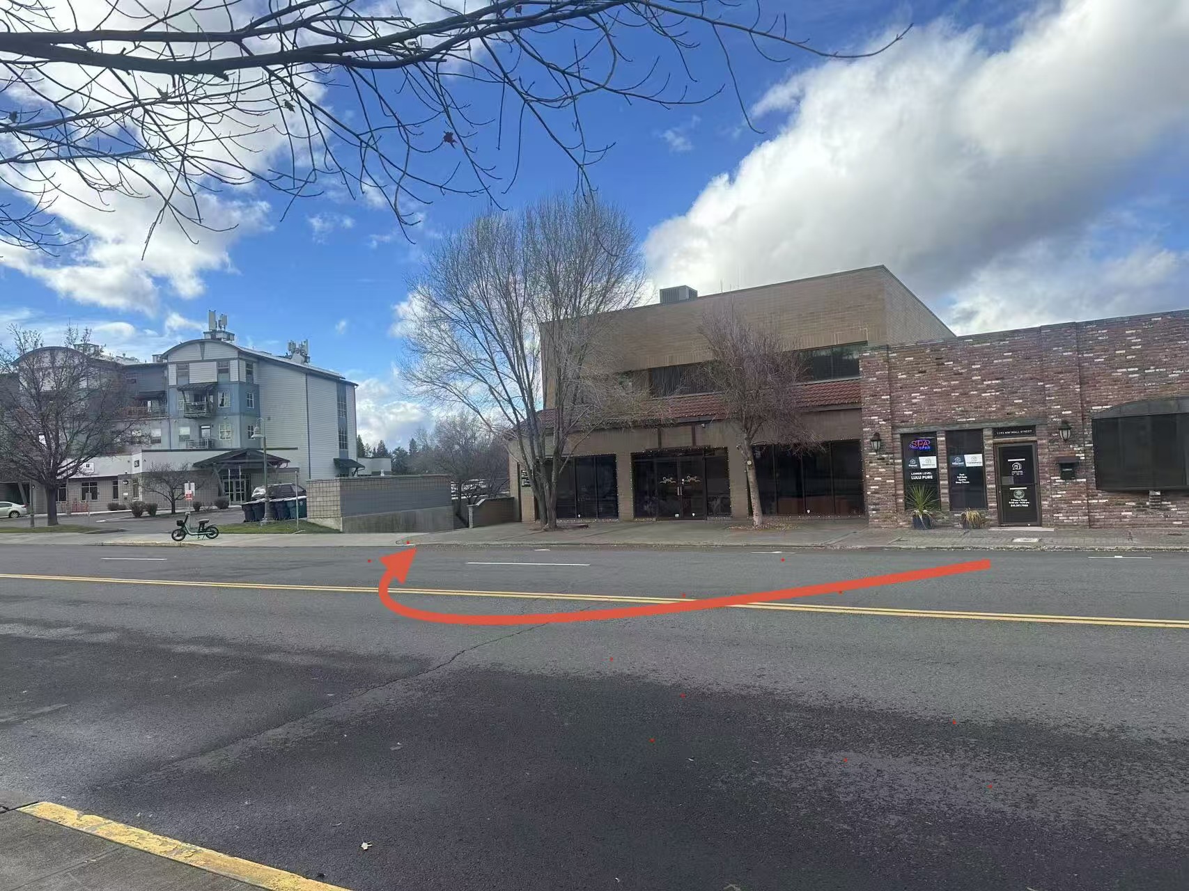 Store entrance on Wall Street — follow the orange arrow to our large parking lot